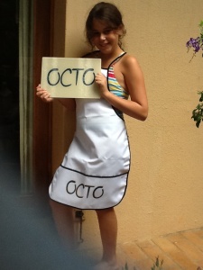Isabella showing off our specially designed apron and cutting board for the OCTO kitchen.